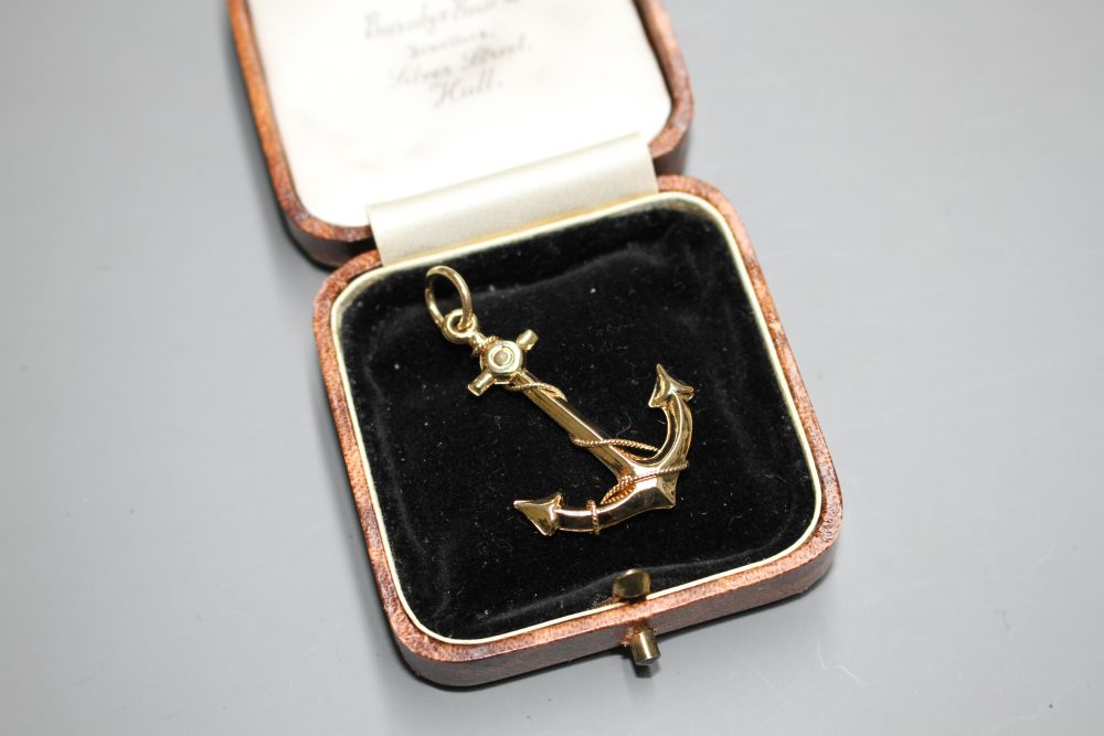 A yellow metal pendant, modelled as an anchor,